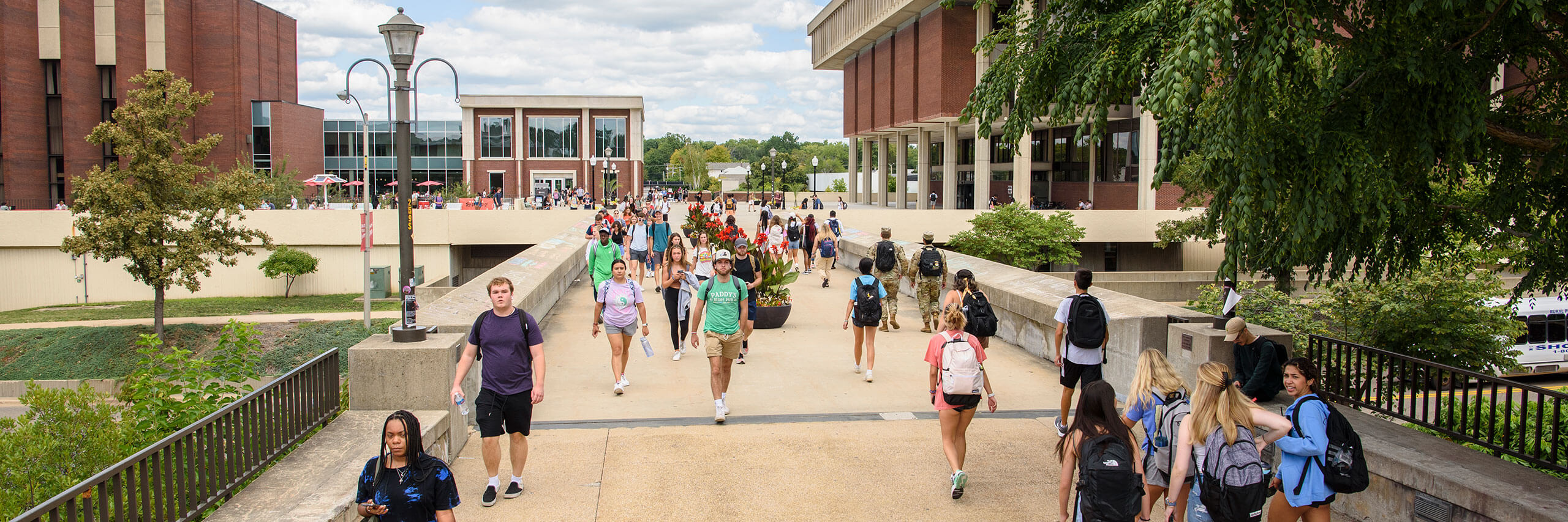 Students walking across the ISU bridge.