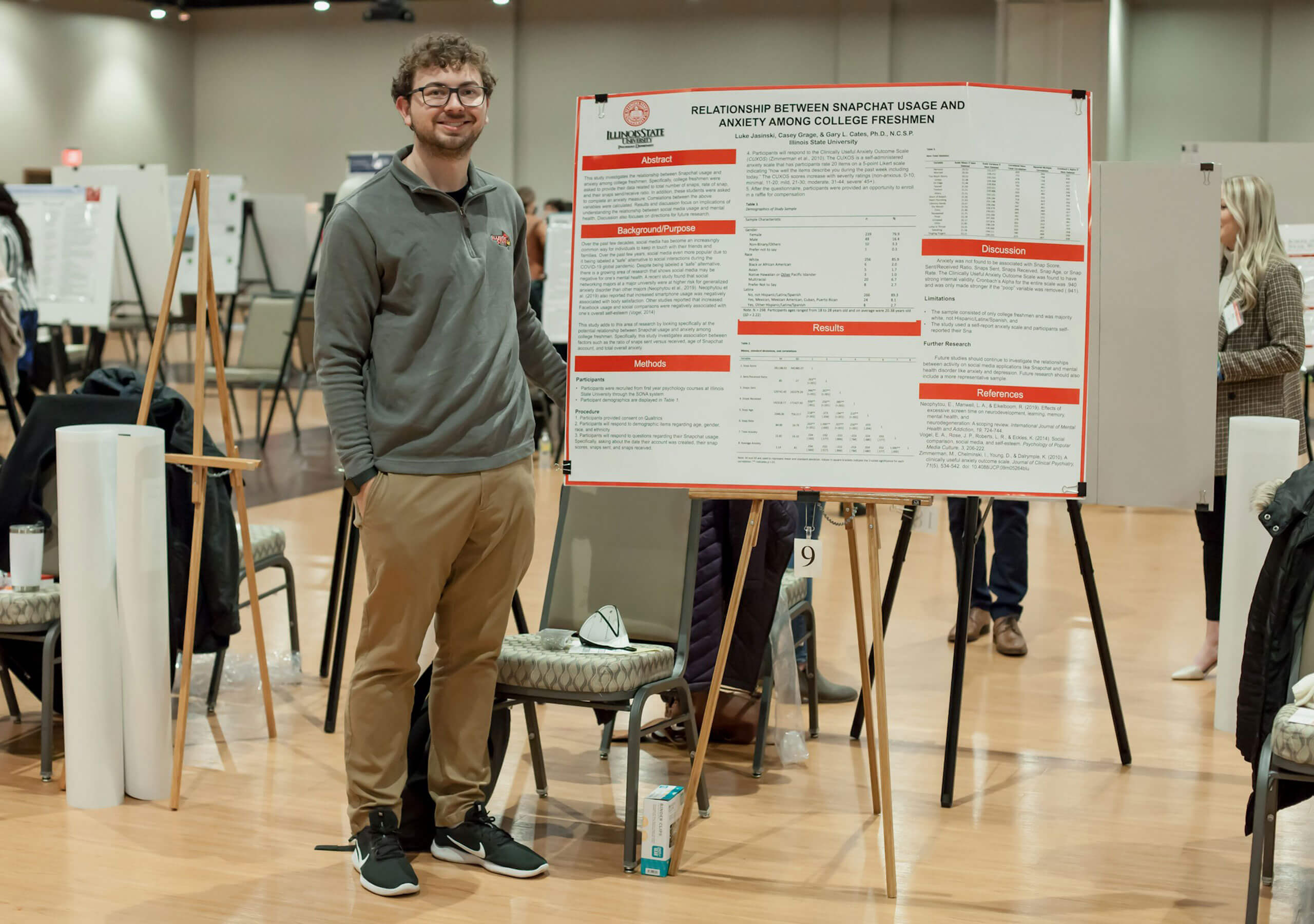 A student displaying their research poster.