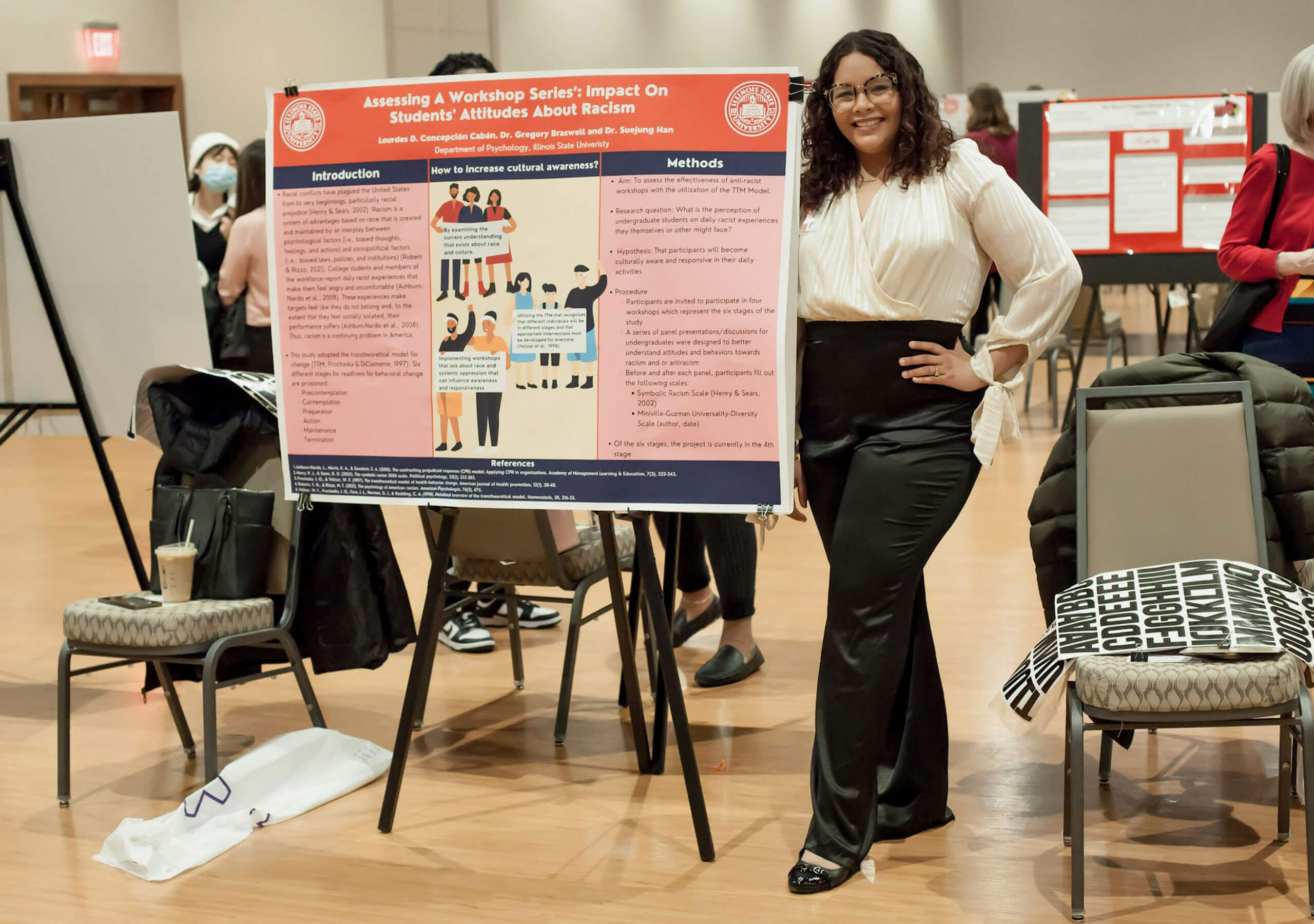 A student explaining their research poster.